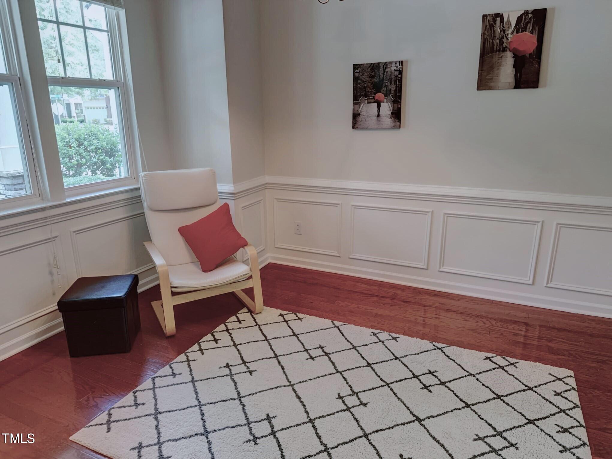 7608 Morrell Lane Durham, NC 27713 - Photo 4 of 34 a living room with a rug and a wooden floor