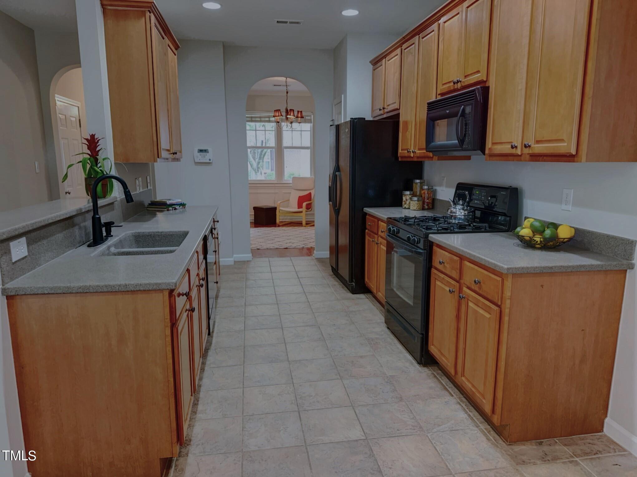 7608 Morrell Lane Durham, NC 27713 - Photo 7 of 34 a kitchen with stainless steel appliances granite countertop a refrigerator stove and a sink