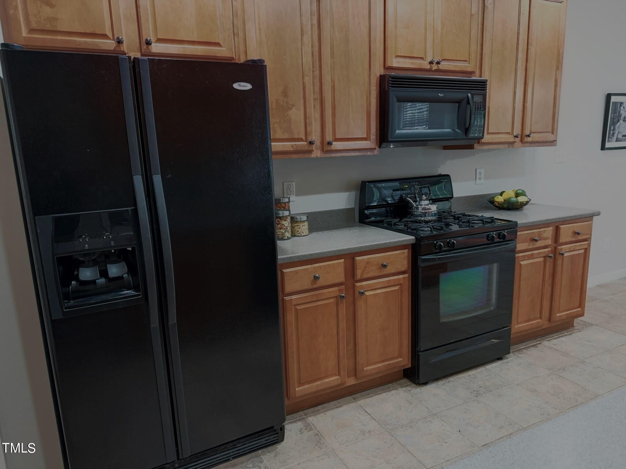 7608 Morrell Lane Durham, NC 27713 - Photo 8 of 34 a kitchen with a refrigerator stove and cabinets