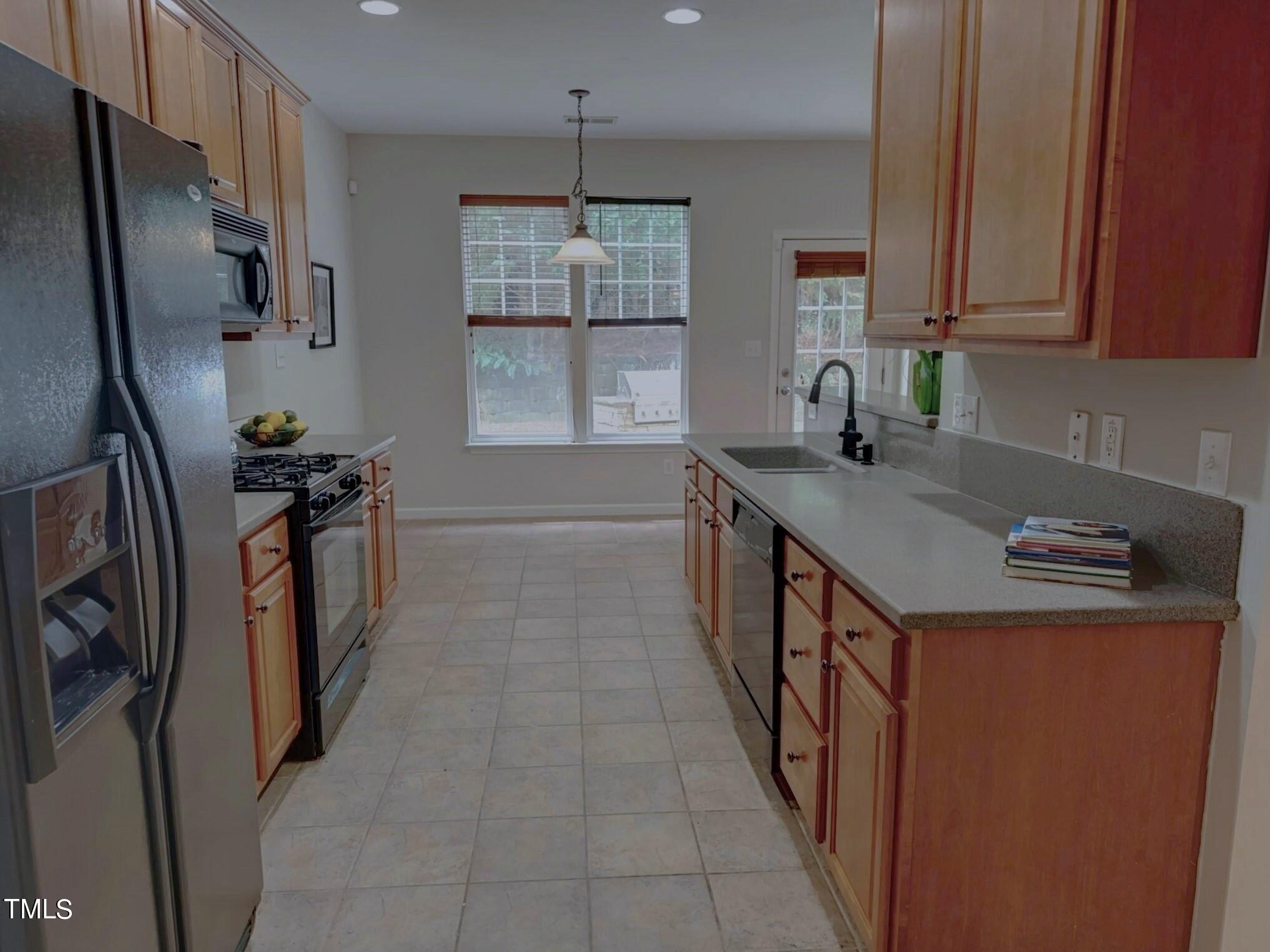 7608 Morrell Lane Durham, NC 27713 - Photo 9 of 34 a kitchen with stainless steel appliances granite countertop a sink stove and refrigerator