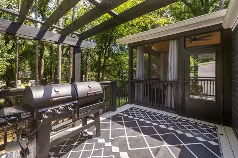 a view of a patio with a dining table and chairs with wooden floor