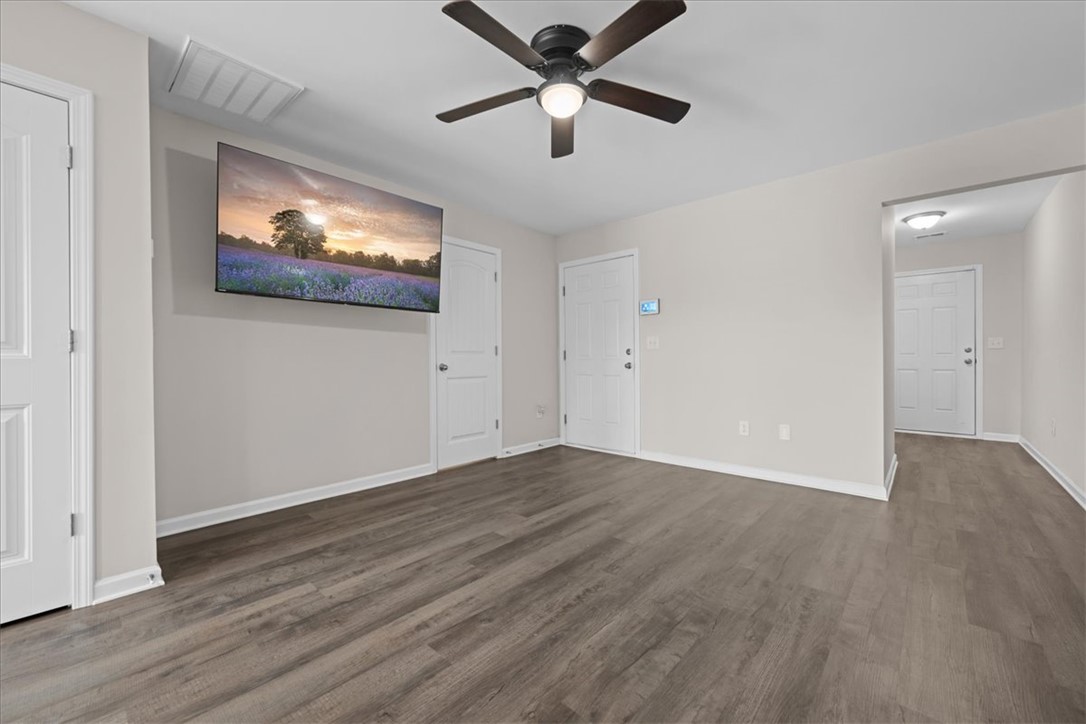 115 Adger Road Pendleton, SC 29670 - Photo 5 of 36 Streamlined living room with robust plank flooring and a modern ceiling fan for ultimate comfort.