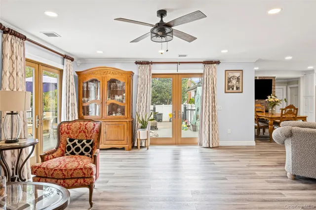 a living room with furniture or chandelier and a wooden floor