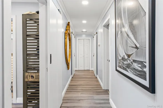 a view of a hallway with wooden floor and stairs