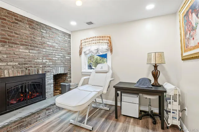 a living room with furniture a fireplace and a table