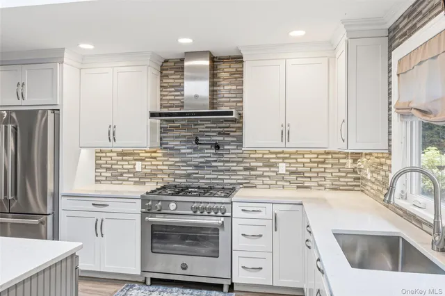 a kitchen with granite countertop a sink stove and refrigerator