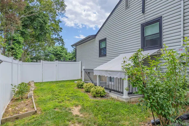 a view of a house with a yard and sitting area