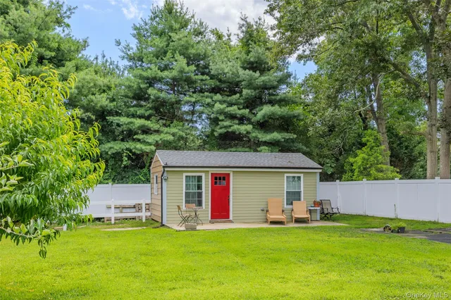 a view of a house with a yard and sitting area