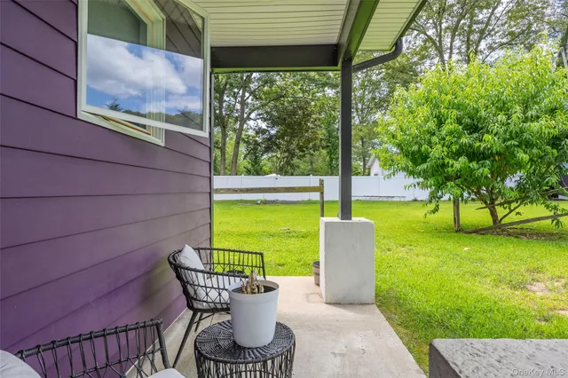 a view of a chair and table in the patio