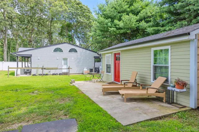 a backyard of a house with table and chairs