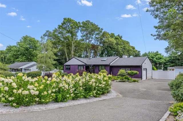 a front view of a house with a yard and fountain