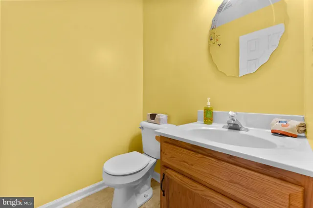 an empty room with a window and a chandelier fan