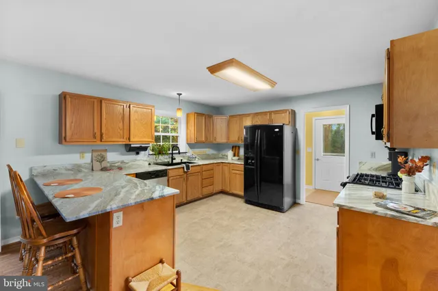 a kitchen with a sink a refrigerator and window