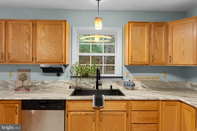 a kitchen with stainless steel appliances granite countertop a sink stove and microwave
