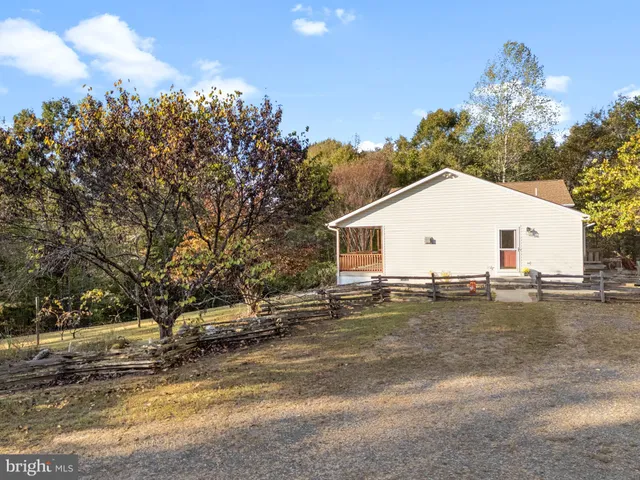 a view of a roof deck with wooden floor and a yard