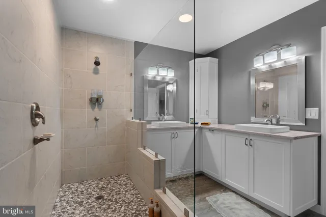 a bathroom with a bathtub a sink and a mirror