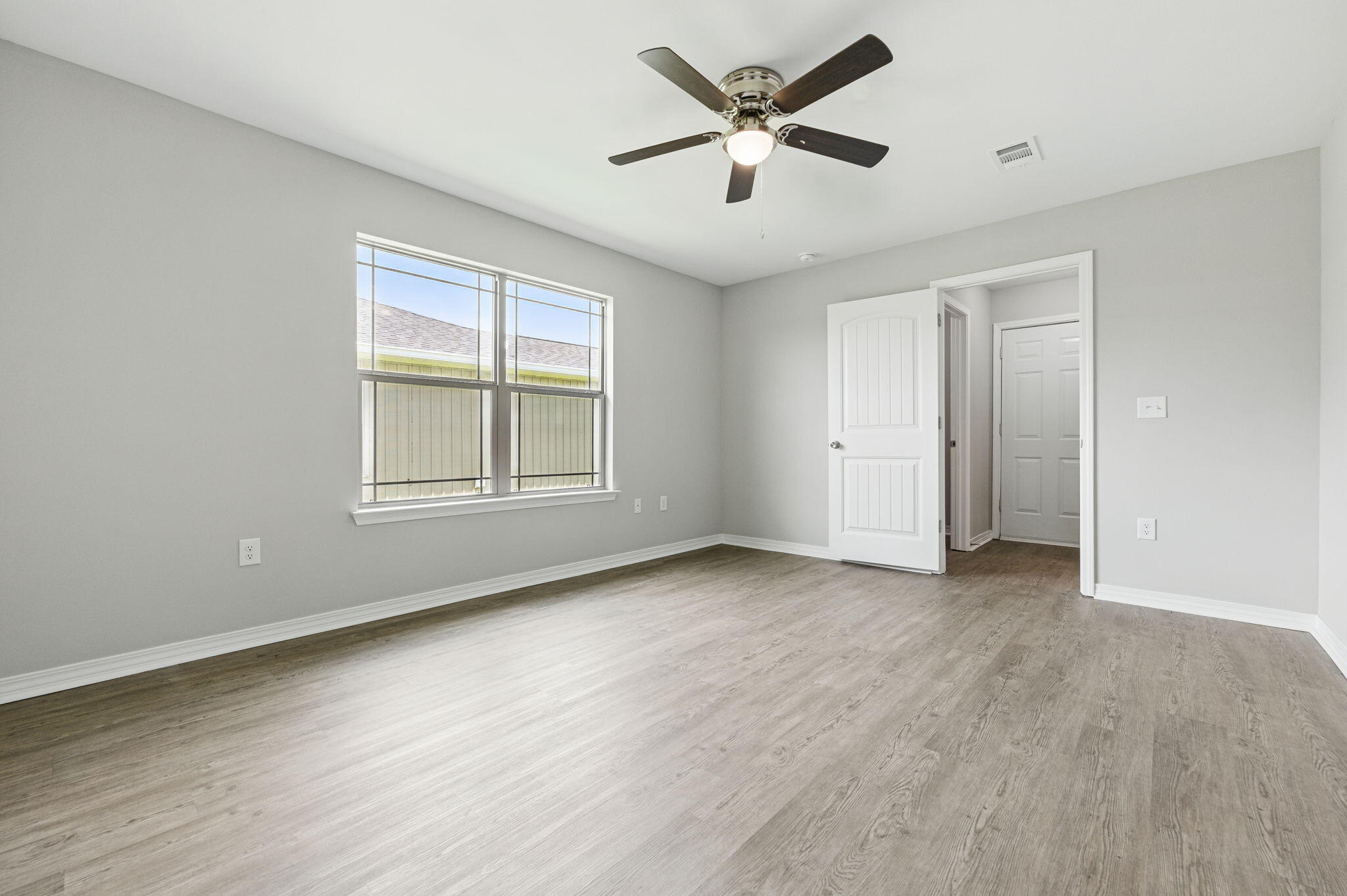 3541 Godwin Road Jay, FL 32565 - Photo 11 of 28 an empty room with wooden floor and windows