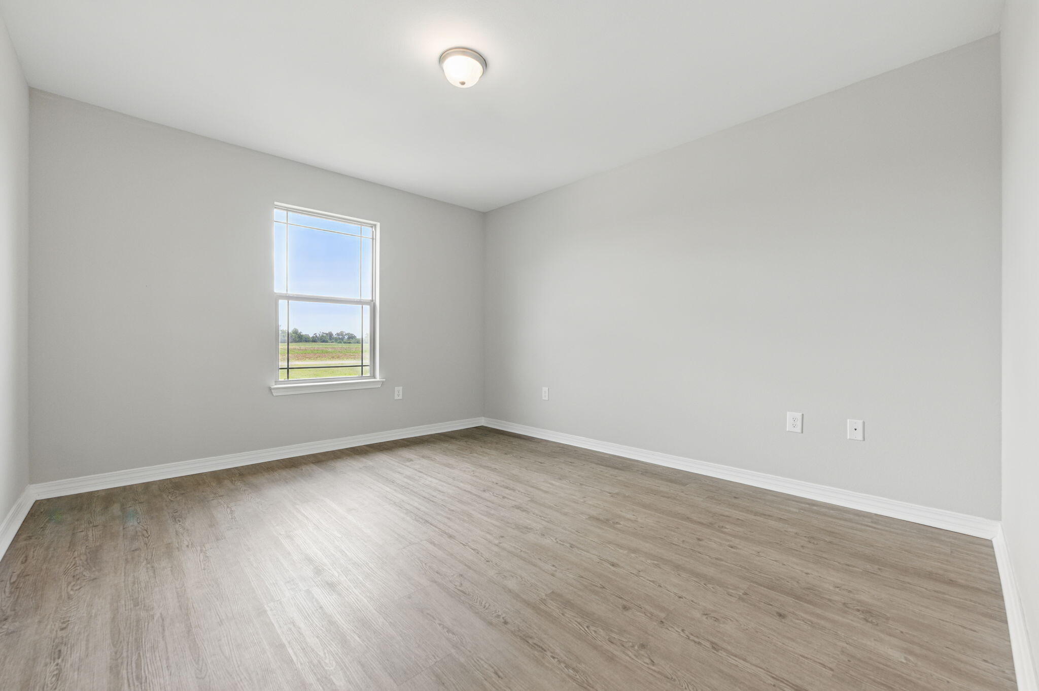 3541 Godwin Road Jay, FL 32565 - Photo 16 of 28 an empty room with wooden floor and windows