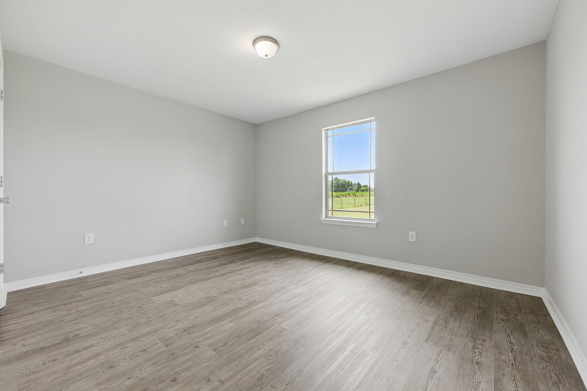 3541 Godwin Road Jay, FL 32565 - Photo 20 of 28 an empty room with wooden floor and windows