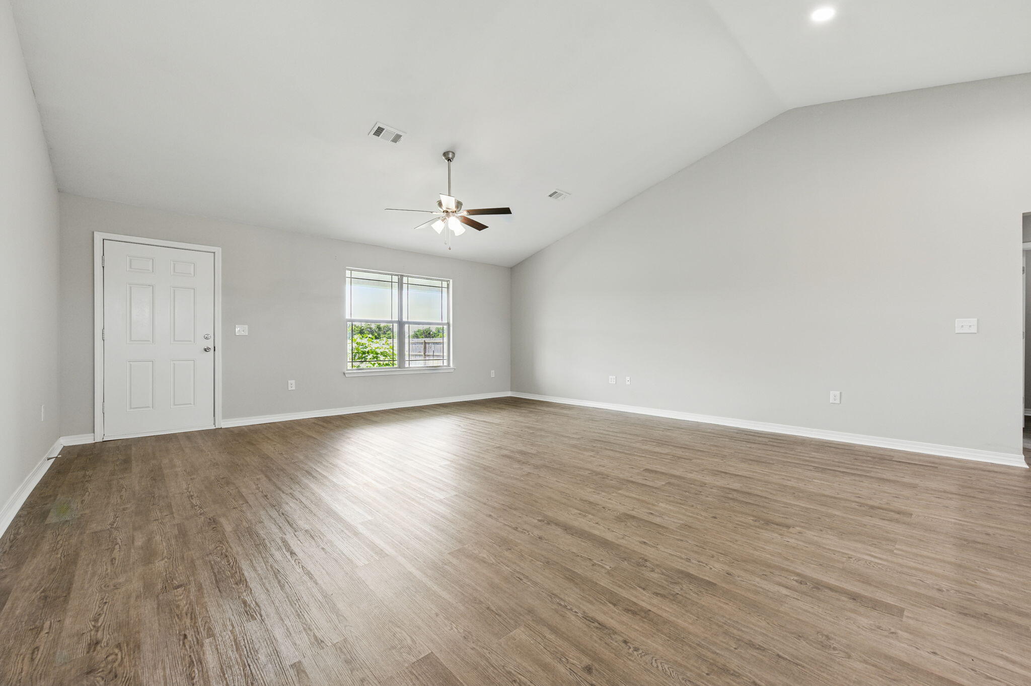 3541 Godwin Road Jay, FL 32565 - Photo 5 of 28 an empty room with wooden floor and windows