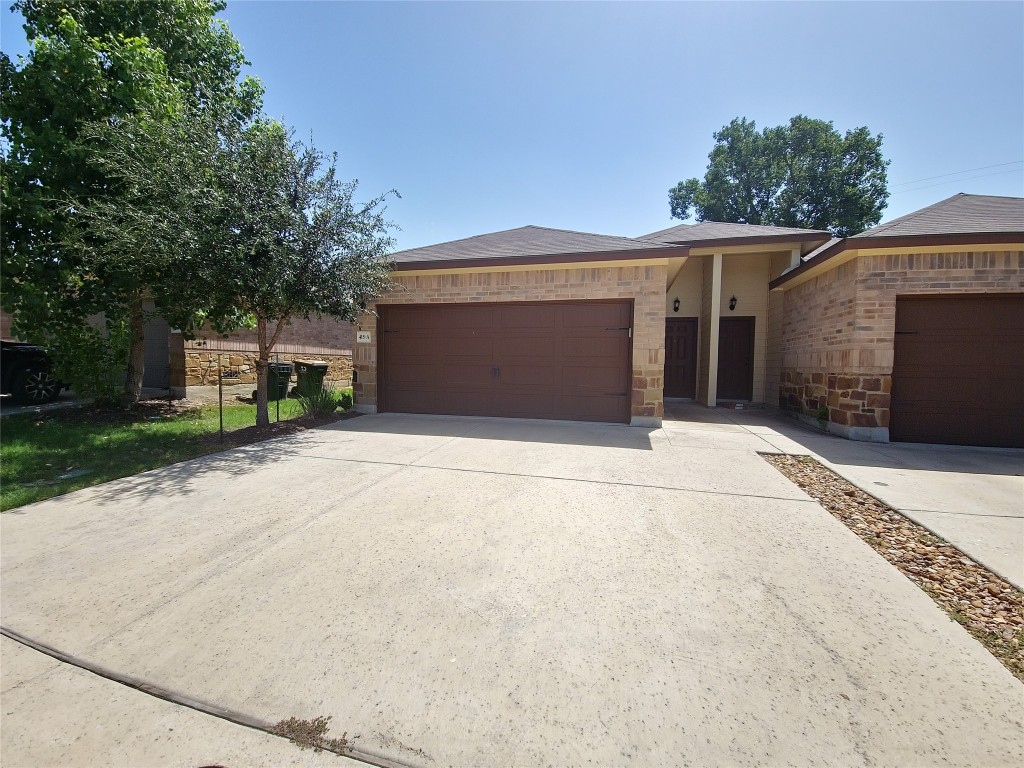 415 Joanne Loop, Unit A Buda, TX 78610 - Photo 1 of 1 front view of a house with a yard