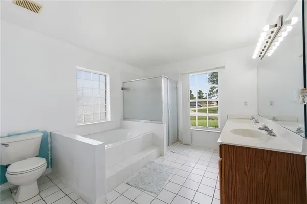 a spacious bathroom with a bathtub sink and toilet
