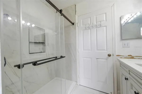 a bathroom with a sink a mirror and a shower