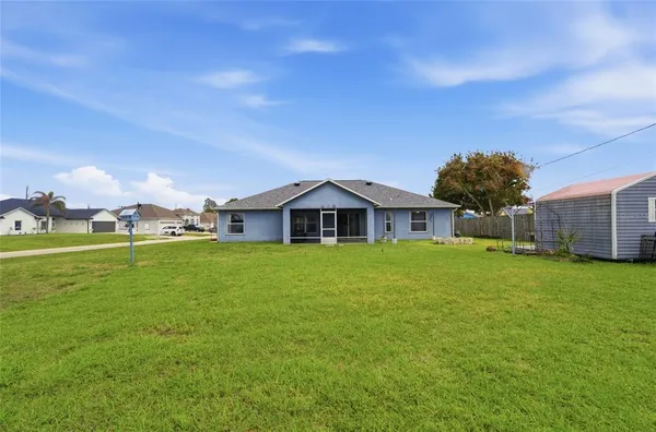 a view of a house with a yard and garage