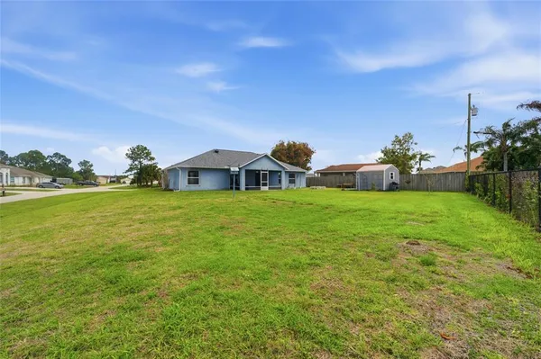 a view of a house with a yard and sitting area