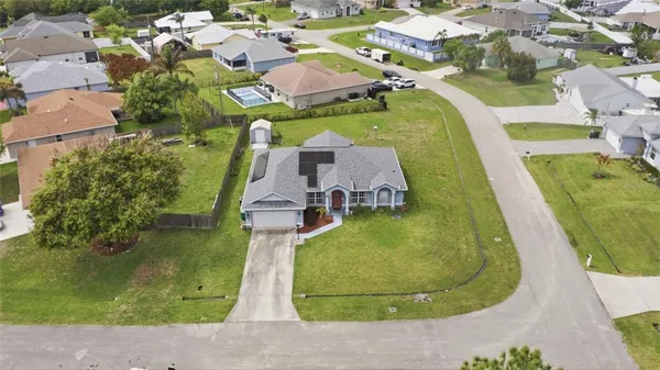 an aerial view of a house with a swimming pool