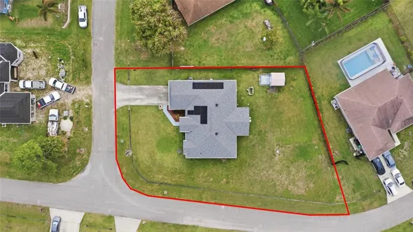 an aerial view of residential houses with outdoor space and swimming pool