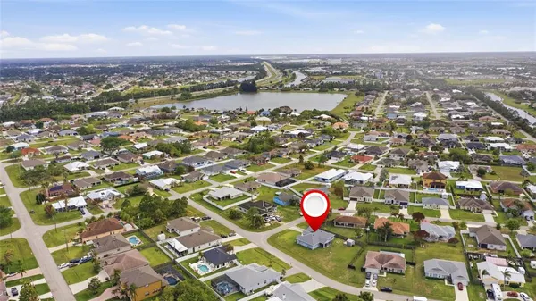 an aerial view of a residential houses with a outdoor space