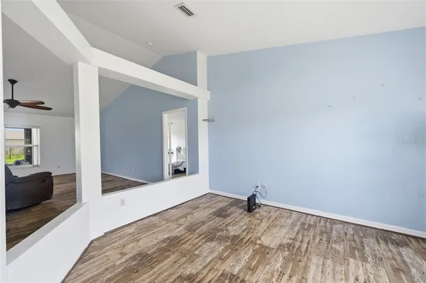 a view of a livingroom with wooden floor and a ceiling fan