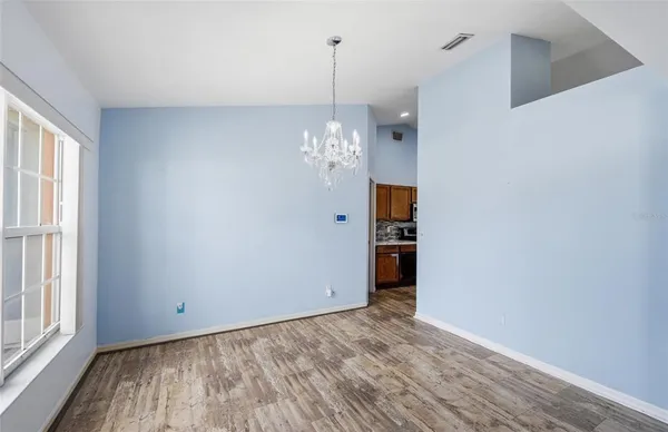 a view of a room with window and wooden floor