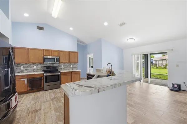 a kitchen with a stove a sink and a refrigerator