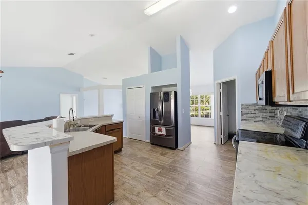 a kitchen with stainless steel appliances a sink stove and refrigerator