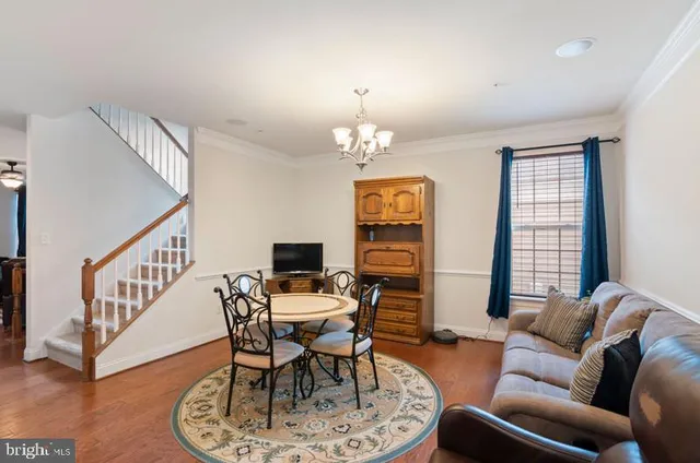 a living room with furniture a chandelier and a window