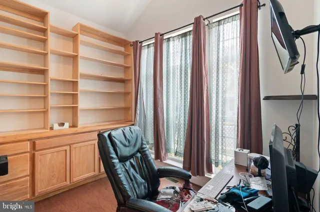 a view of a livingroom with furniture and a window
