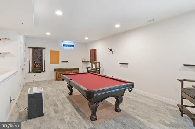 a room with table chairs and wooden floor