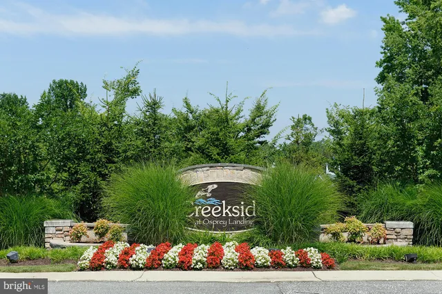 a view of sign board with flower around