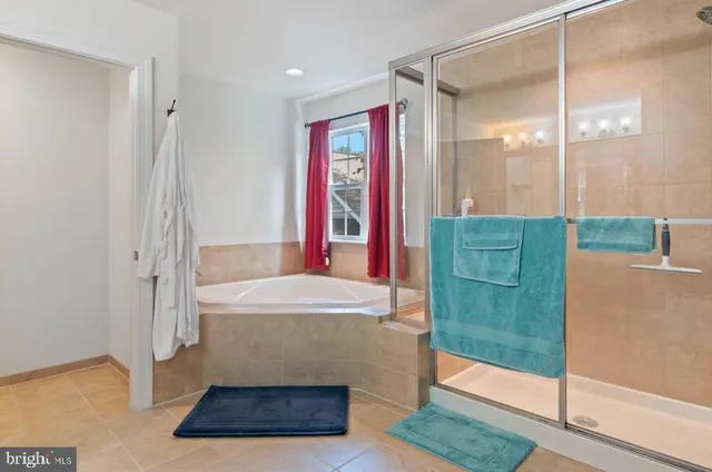 a bathroom with a tub shower and sink
