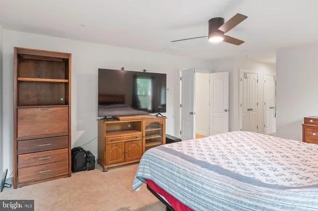 a bedroom with a bed and a television