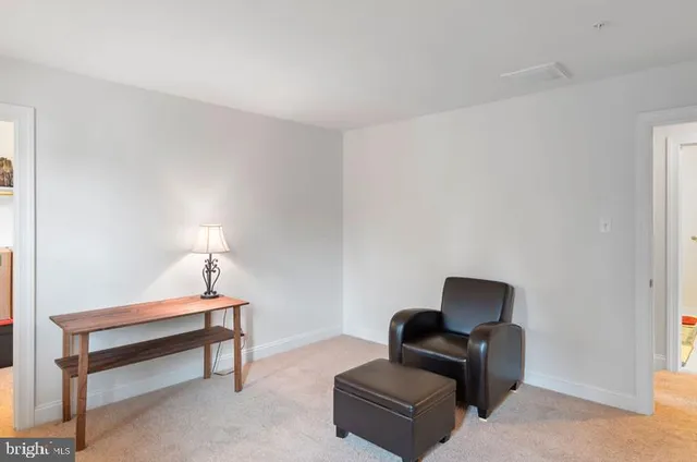 a bedroom with furniture and a lamp