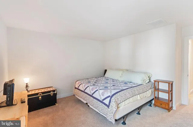 a bedroom with a bed and a tv