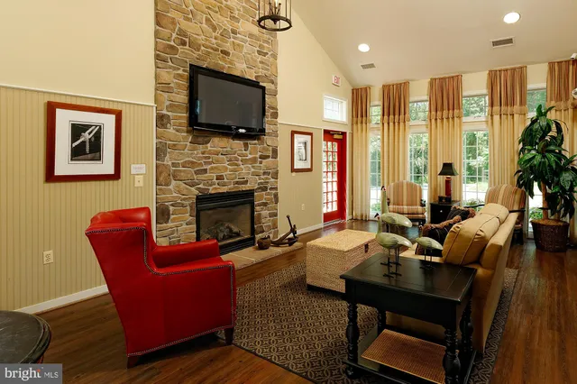 a living room with fireplace furniture and a flat screen tv