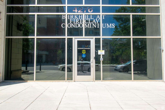 4276 South Main Street, Unit 303 Murray, UT 84107 - Photo 16 of 20 Modern commercial facade featuring extensive glass paneling and a central glass entry door