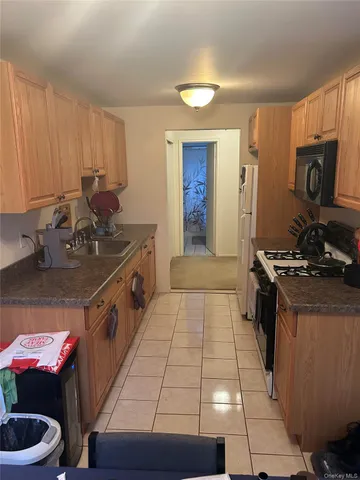 a kitchen with a sink appliances and cabinets