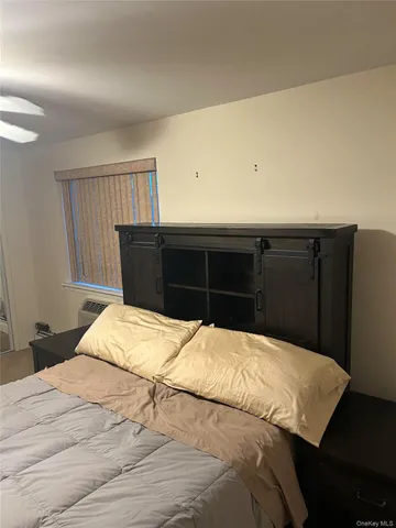 a bedroom with a bed and dresser