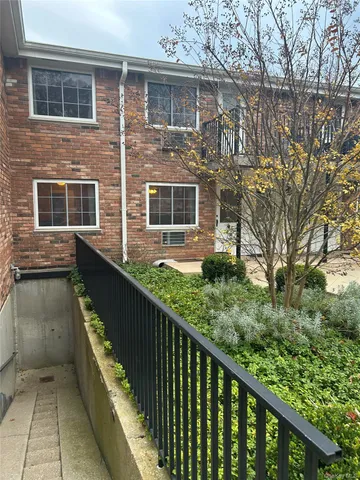 a view of a brick house with a large windows