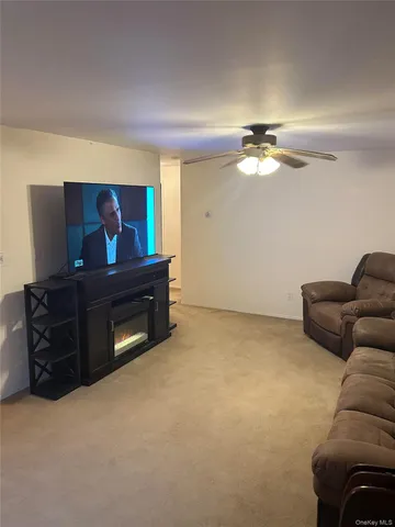 a living room with furniture and a dresser